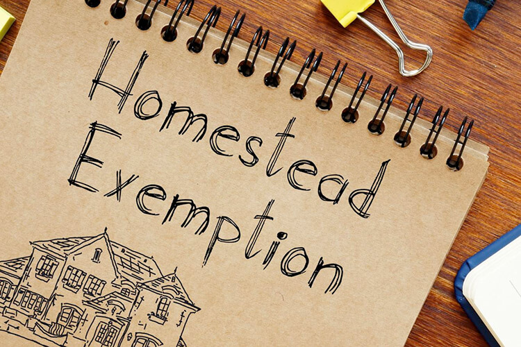 image of a notepad on a desk with a sketch of a house and the words homestead exemption